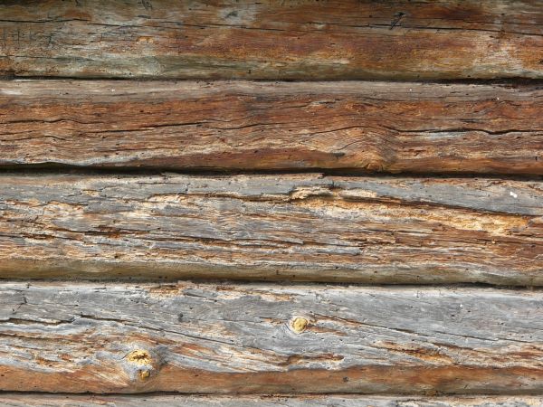 Very old grey planks with fading paint and very rough surfaces.